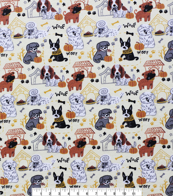 Close up of pumpkin spice fabric, showing different types of dogs with dog houses and bones